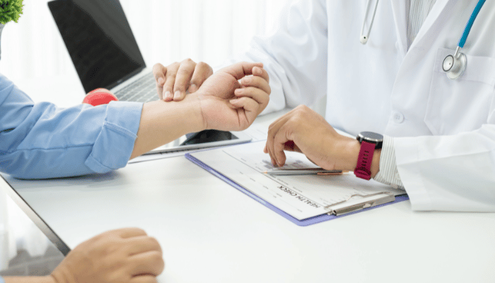 doctor examining patient wrist(1)